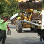 workers cleaning up a flooded street