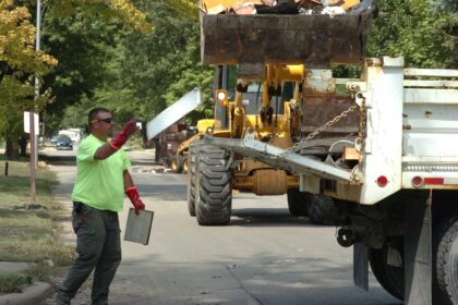 workers cleaning up a flooded street