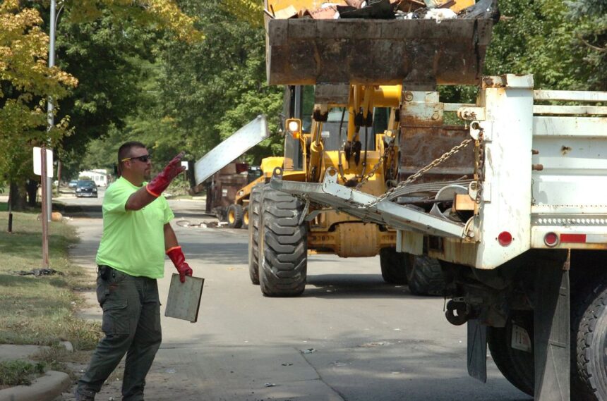 workers cleaning up a flooded street