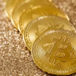Golden Bitcoin coins on a glittering background