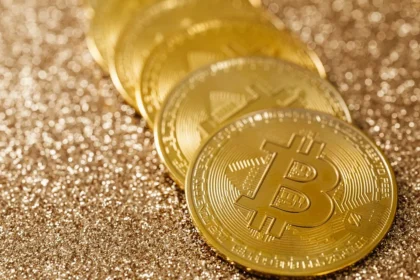 Golden Bitcoin coins on a glittering background