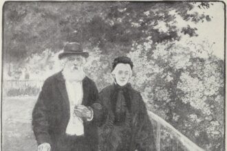 An elderly couple walking together through a green park on a sunny day