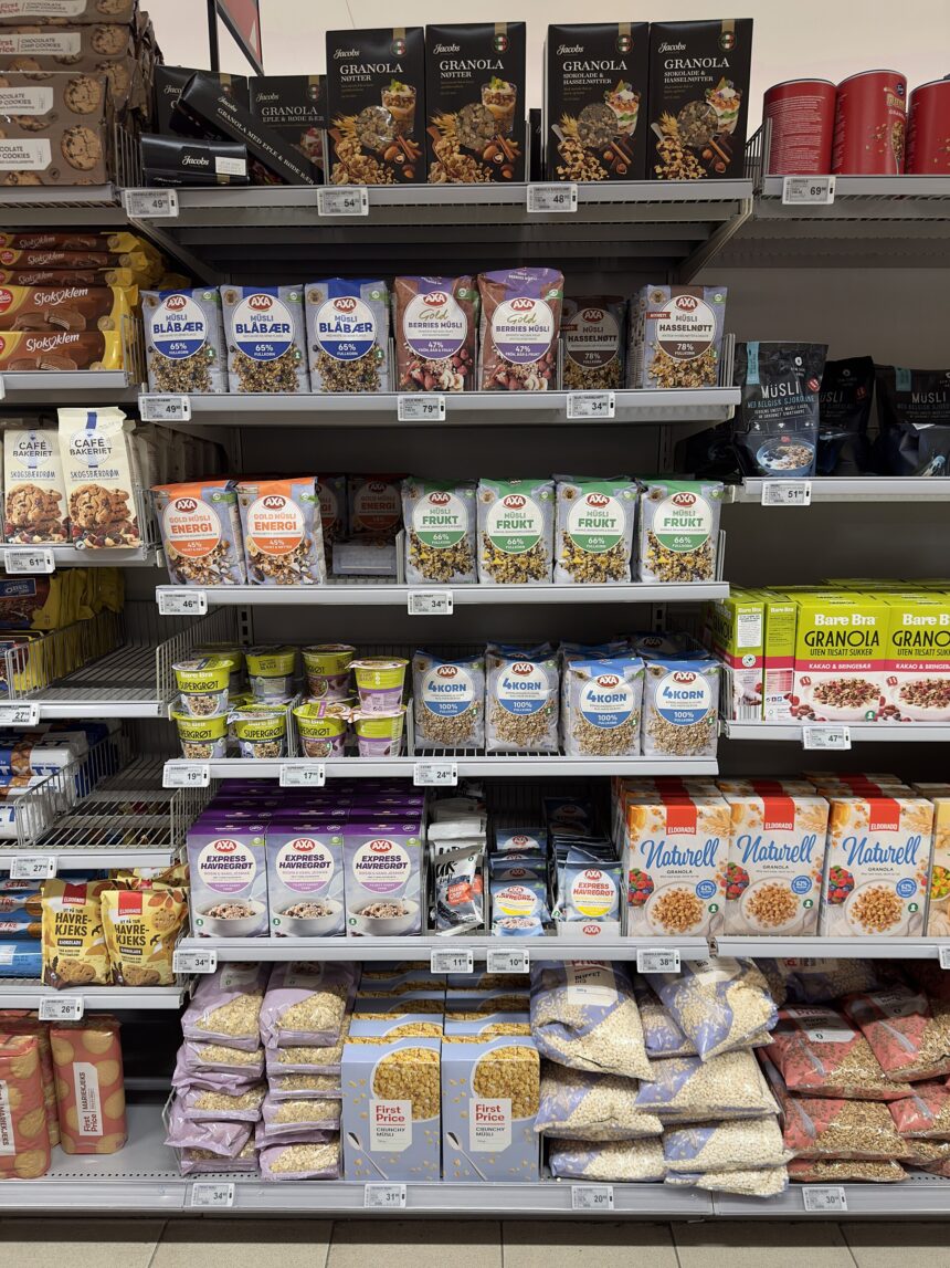 Supermarket shelves stocked with colourful packaged food products in an aisle