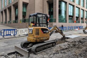 Caterpillar excavator construction photo illustrating tariff costs
