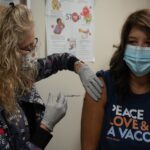 Healthcare worker preparing a measles MMR vaccination dose
