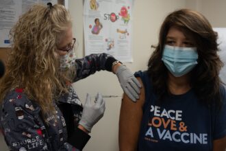 Healthcare worker preparing a measles MMR vaccination dose