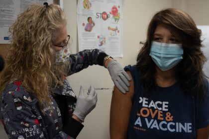 Healthcare worker preparing a measles MMR vaccination dose