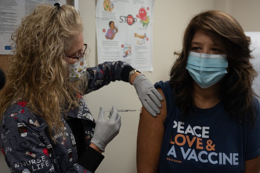 Healthcare worker preparing a measles MMR vaccination dose